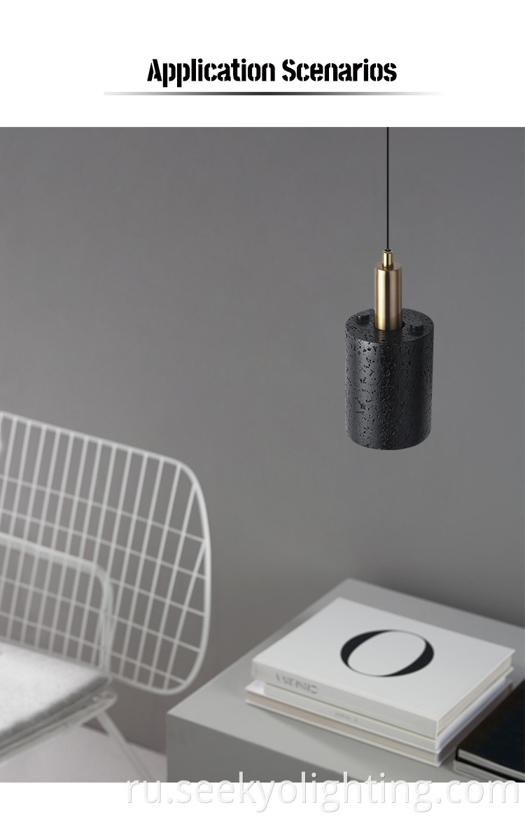 The black stone pendant lamp is designed to hang from the ceiling, providing ample lighting for the dining area below.